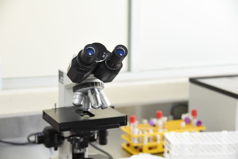 Laboratory microscope and test tubes representing top universities in USA for forensic science